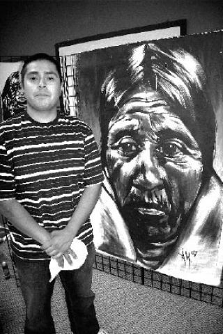 Andrew Morrison of Seattle shows off artwork at his booth during the Paddle Snoqualmie Tribal Store Art Show