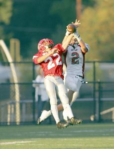 Sophomore Matthew Bankston goes airborne to interecpt a pass against an Eastlake defender. The Wildcat defense played a solid game but the offense struggled until the fourth quarter.