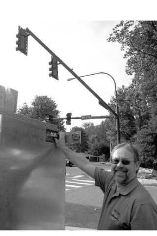 North Bend Mayor Ken Hearing flips a switch activating new traffic lights at the intersection of Park Street and Bendigo Boulevard. The $430