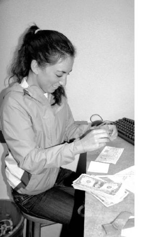 Mount Si accounting student Jenn Clarke counts cash at the school’s Wildcat Branch of the Sno Falls Credit Union