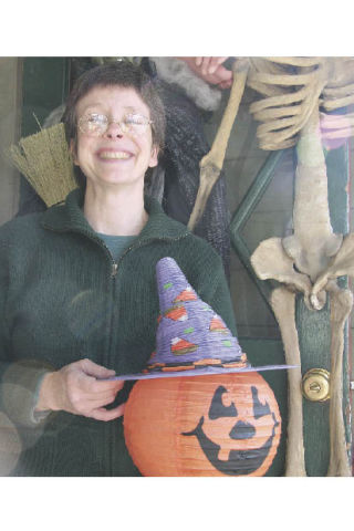 Wendy Thomas of Carmichael’s True Value Hardware decorates her downtown Snoqualmie store for Halloween. Downtown businesses host a candy harvest for children and families