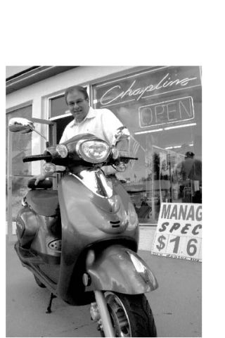 Chaplin Chevrolet manager Frank Protzman shows off one of the dealership’s new line of motorscooters. Protzman said the gas-efficient rides are ideal for short Valley commutes