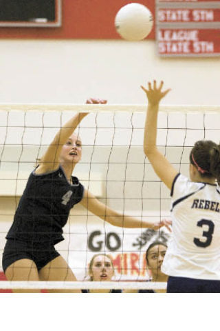 Mount Si’s Aubrey Larion spikes the ball against Juanita’s Annie Brandon during play last week.