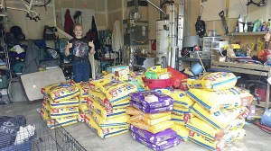Courtesy PhotoCaroline McCall shows off hundreds of pounds of pet food bought with the money donated through gofundme.com