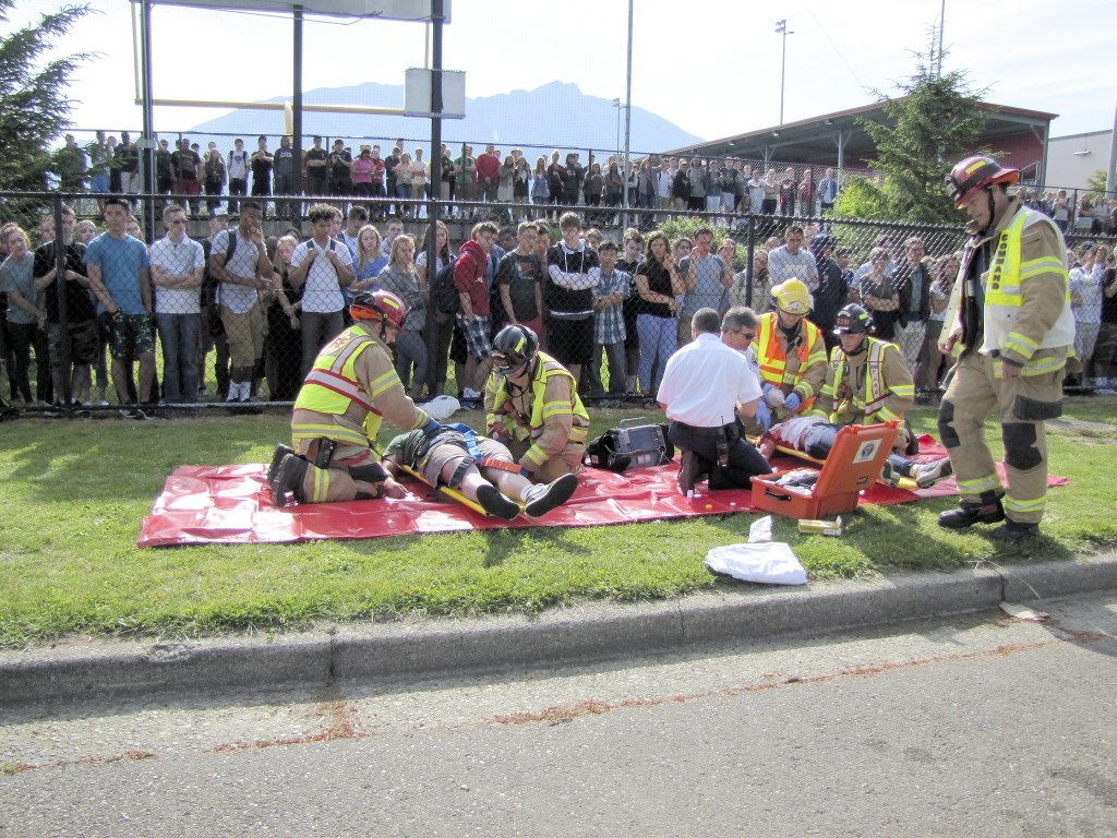 Photos courtesy of Marla Gall The Snoqualmie Fire and Police departments demonstrated how they handle a car crash in front of a live audience of Mount Si High School students for a mock crash exercise during the school’s Think and Drive week to deter drinking and driving.