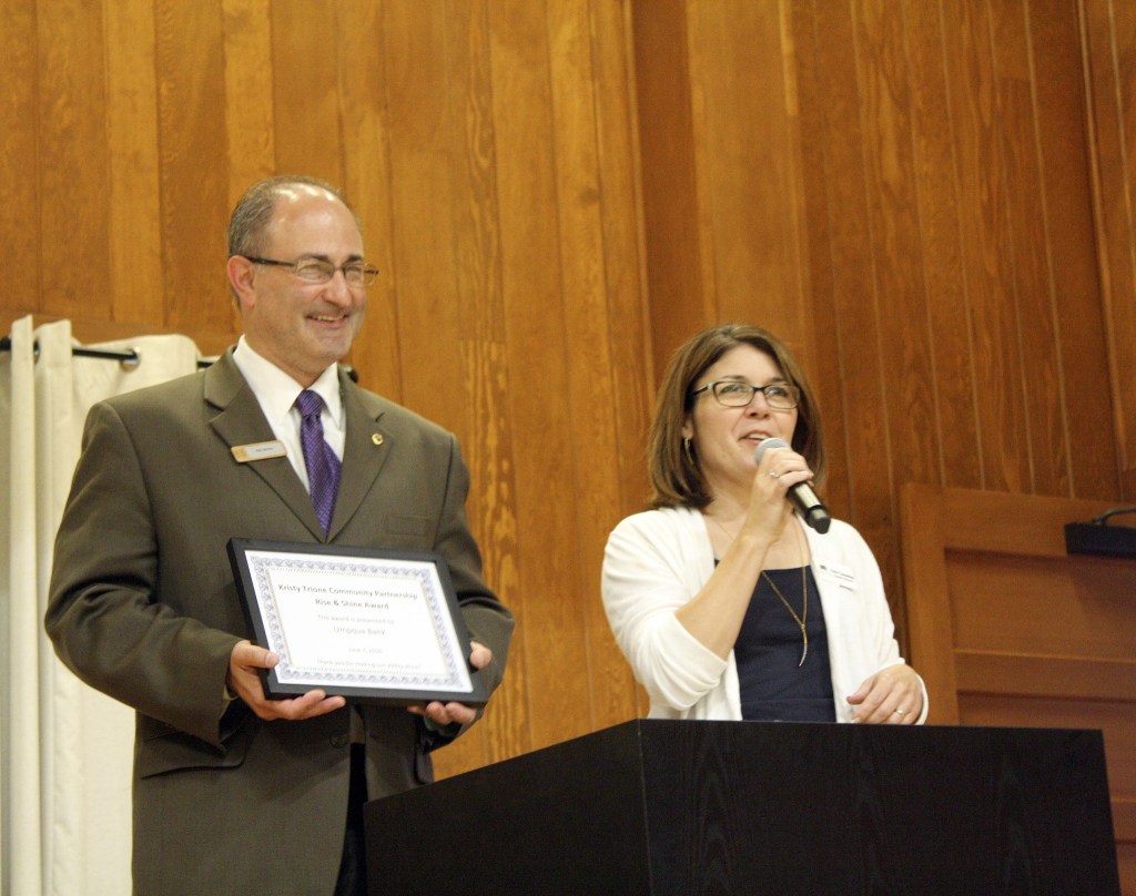Rob Wotton received the Kristy Trione Community Partnership award while Encompass Executive Director Nela Cumming spoke about his volunteer efforts.
