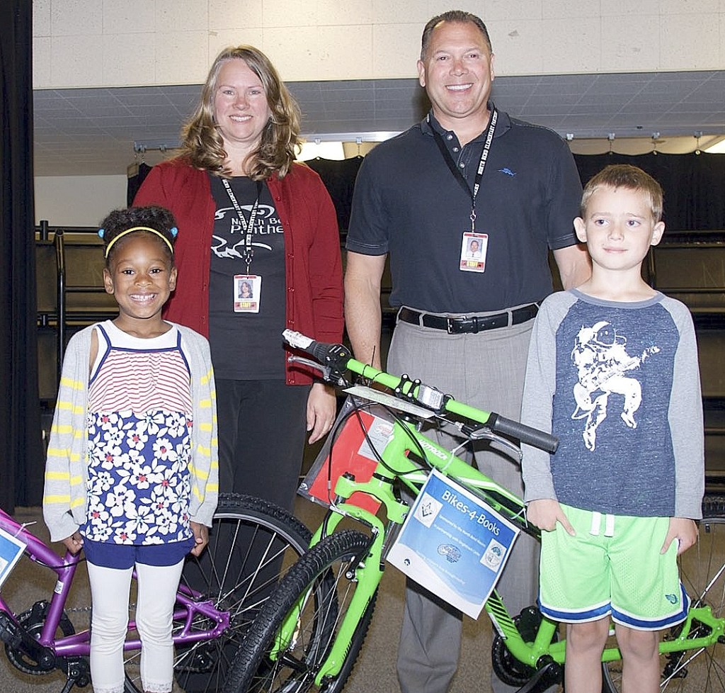 Courtesy PhotoNorth Bend Elementary teacher Julie Gardunia and Principal Jim Frazier presented the schools Bikes for Books winners Lilyan Cummings