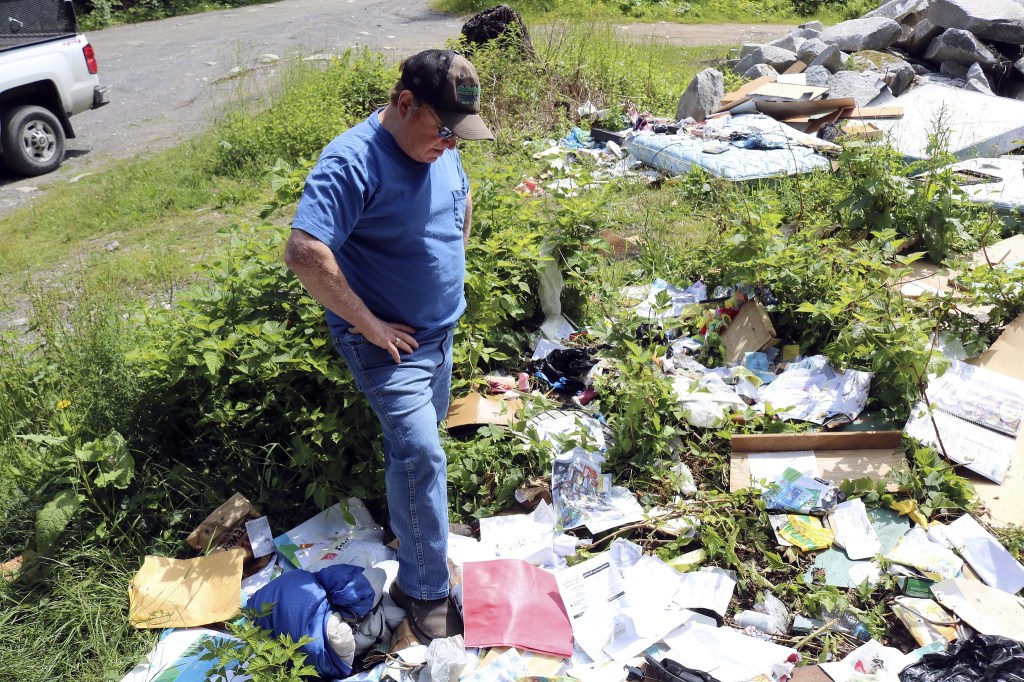 Evan Pappas/Staff PhotoFriends of the Trail founder Wade Holden finds a site filled with trash on Tinkham Road along the Middle Fork.