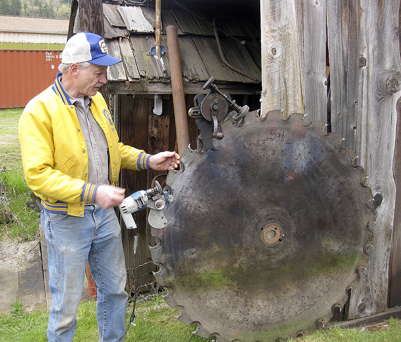 Duane Isackson sharpens a saw blade at his family’s sawmill