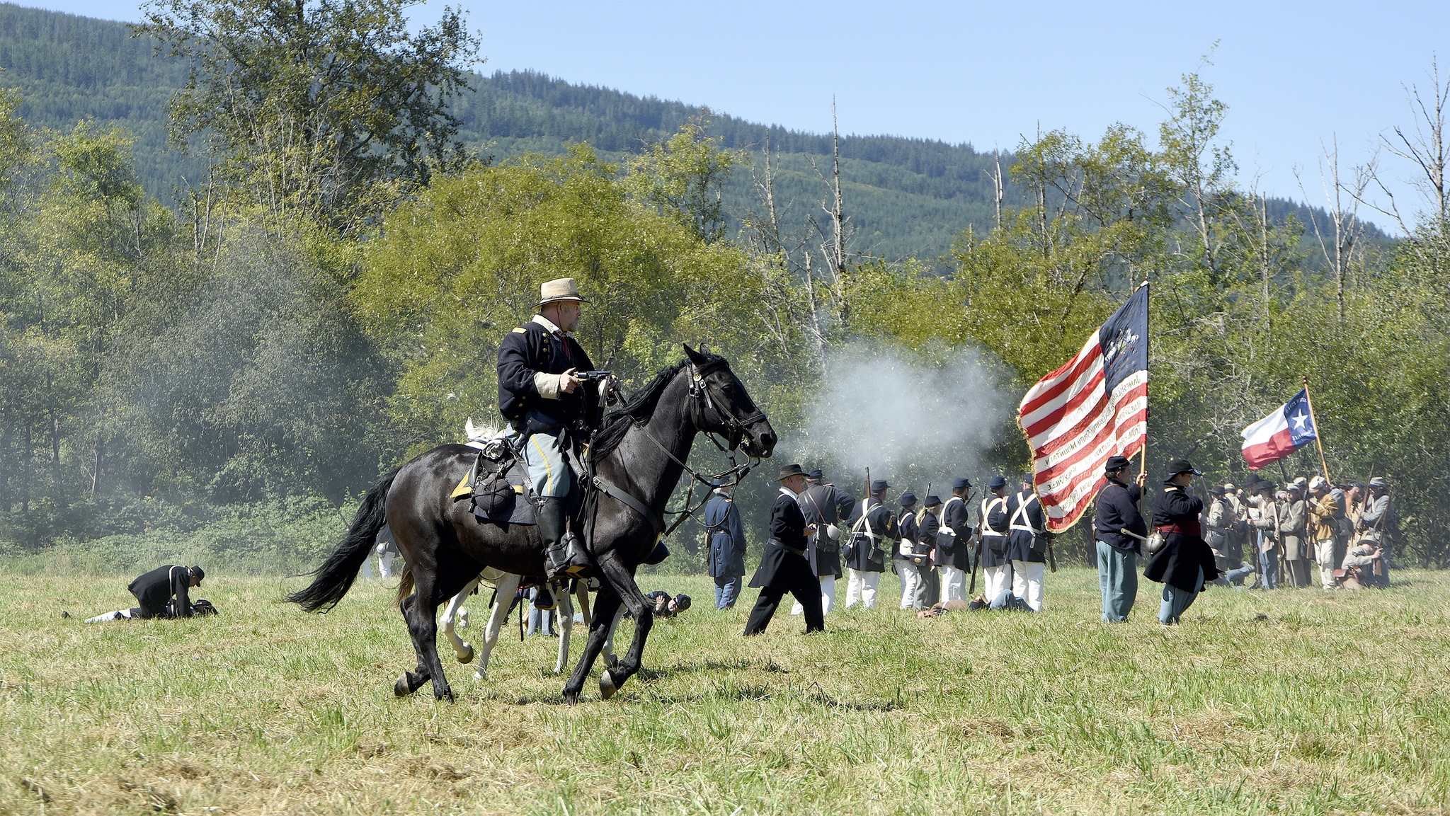 A Union cavalry man follows the foot soldiers into battle Sunday morning as re-enactors demonstrated a Civil War-era clash on Meadowbrook Farm.