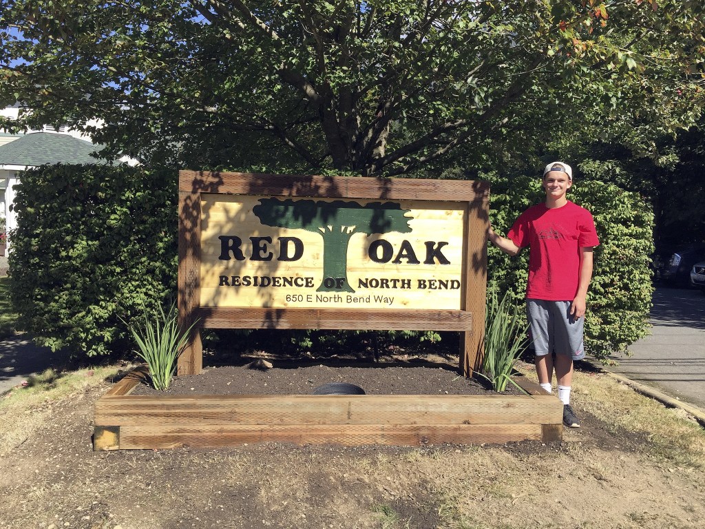 Evan Pappas/Staff PhotoStone stands with his completed and installed sign on Sept. 11