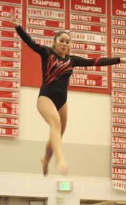 Wildcat all-around leader Hailey Johnson leaps on beam. She led the squad with AA scores last Thursday vs. Sammamish that included a strong vault performance.
