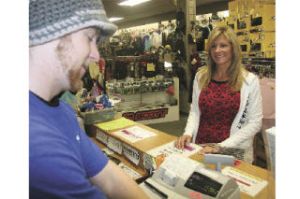 Mount Si Board & Skate employee Tyler Wagner completes a post-Thanksgiving transaction with Lisa Alexander