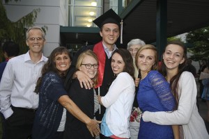 Alex Ward of Carnation gets a group hug from his extended family and friends outside of Overlake Christian Church following Cedarcrest High School commencement Friday