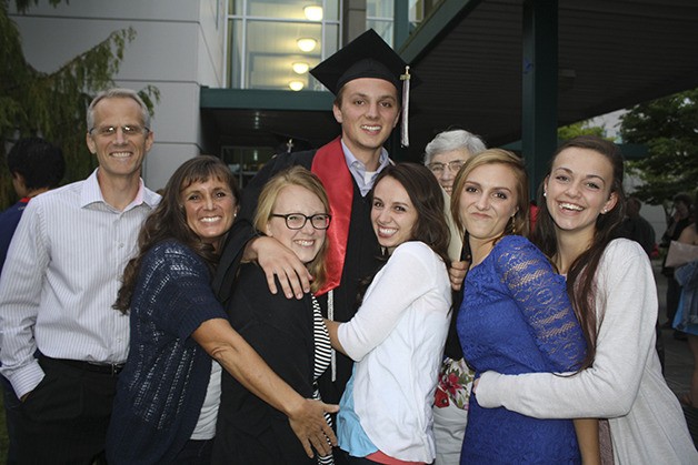 Alex Ward of Carnation gets a group hug from his extended family and friends outside of Overlake Christian Church following Cedarcrest High School commencement Friday