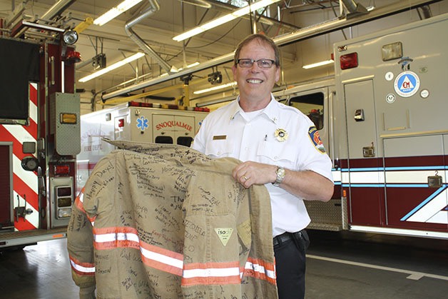 A bunker jacket covered in signatures of Snoqualmie firefighters and city employees is a going-away souvenir for Todd Reynolds