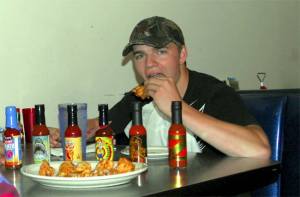McKinley Cook of North Bend warms up for Saturday’s hot wings challenge with a wing at Twede’s Cafe. He’s sampling a milder sauce than Saturday’s line-up