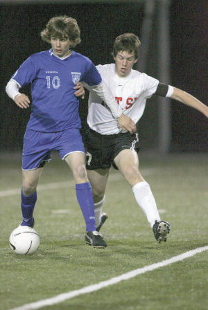 The Wildcats Ben Joselyn pushes his way around a Liberty defender in last weeks 1-0 win over the Patriots. The game went into overtime during which Doug Silvius scored the lone goal.