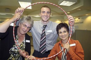 Staff at North Bend's Umpqua Bank show off the hula hoop pass