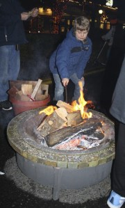 A young man checks out the marshmallow fire at last year's North Bend Holiday Festival. The community event returns this Saturday