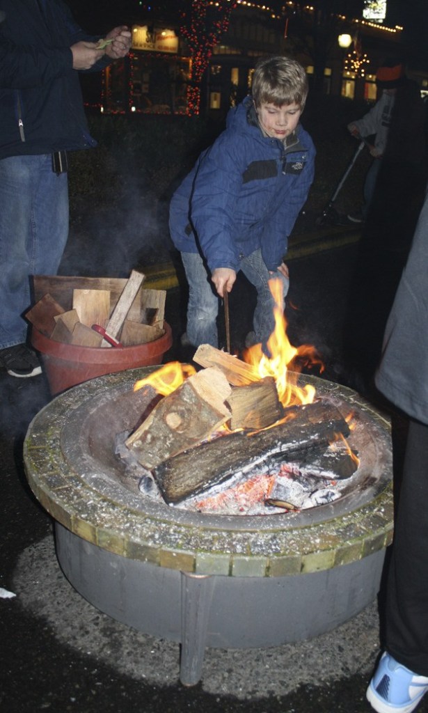 A young man checks out the marshmallow fire at last year's North Bend Holiday Festival. The community event returns this Saturday