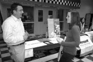 A recruiter for OshKosh B’Gosh describes open retail positions in North Bend to new Valley resident Allison Roberts. The 17-year-old is looking for a part-time job while she studies online.