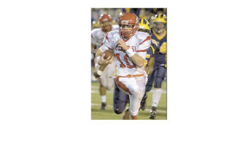 Mount Si quarterback Tyson Riley runs away from the Bellevue defense during last Friday night’s game with the Wolverines