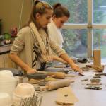 Evan Pappas/Staff Photo                                Elizabeth Ward and Taccoa Herman prepare their clay to be formed into a bowl shape.
