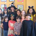 Snoqualmie Smart with Art students, dressed in their Halloween costumes, pose with their teacher at the Snoqualmie Valley Chamber of Commerce building. Front-row from left: Maria Castle, Vendanshi Rahul, Albert Brown and John David Castle. Back-row from left: Bella Vernon, Franchesca Tamburini, Smart with Art Teacher Kori Mankowski, Cynthia Castle, Eva Davison, Hailey Mays and Evelyn Brown. (Evan Pappas/Staff Photo)