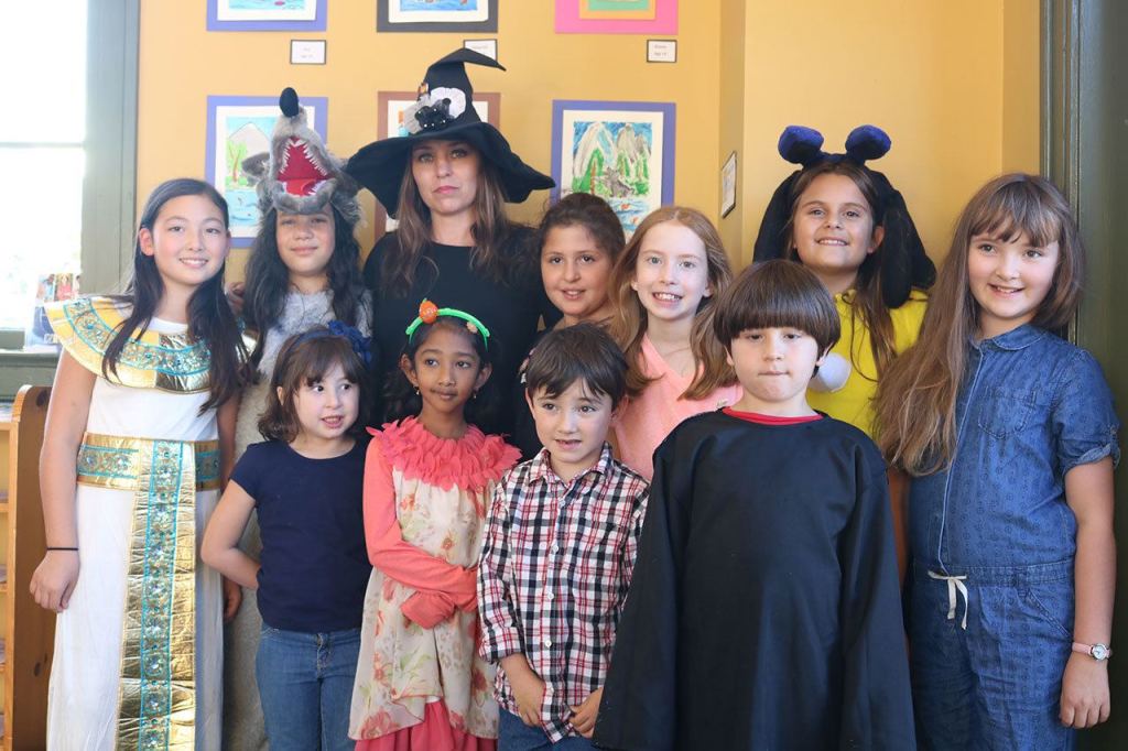 Snoqualmie Smart with Art students, dressed in their Halloween costumes, pose with their teacher at the Snoqualmie Valley Chamber of Commerce building. Front-row from left: Maria Castle, Vendanshi Rahul, Albert Brown and John David Castle. Back-row from left: Bella Vernon, Franchesca Tamburini, Smart with Art Teacher Kori Mankowski, Cynthia Castle, Eva Davison, Hailey Mays and Evelyn Brown. (Evan Pappas/Staff Photo)