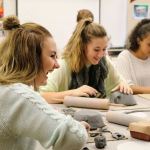 Evan Pappas/Staff Photo                                Ericka Michelson, Sami Lewiston and Josephine Araya, members of the Mount Si High School cheer team, laugh as they get to work in clay, creating dishes for the Empty Bowls dinner benefitting the Snoqualmie Valley Food Bank.