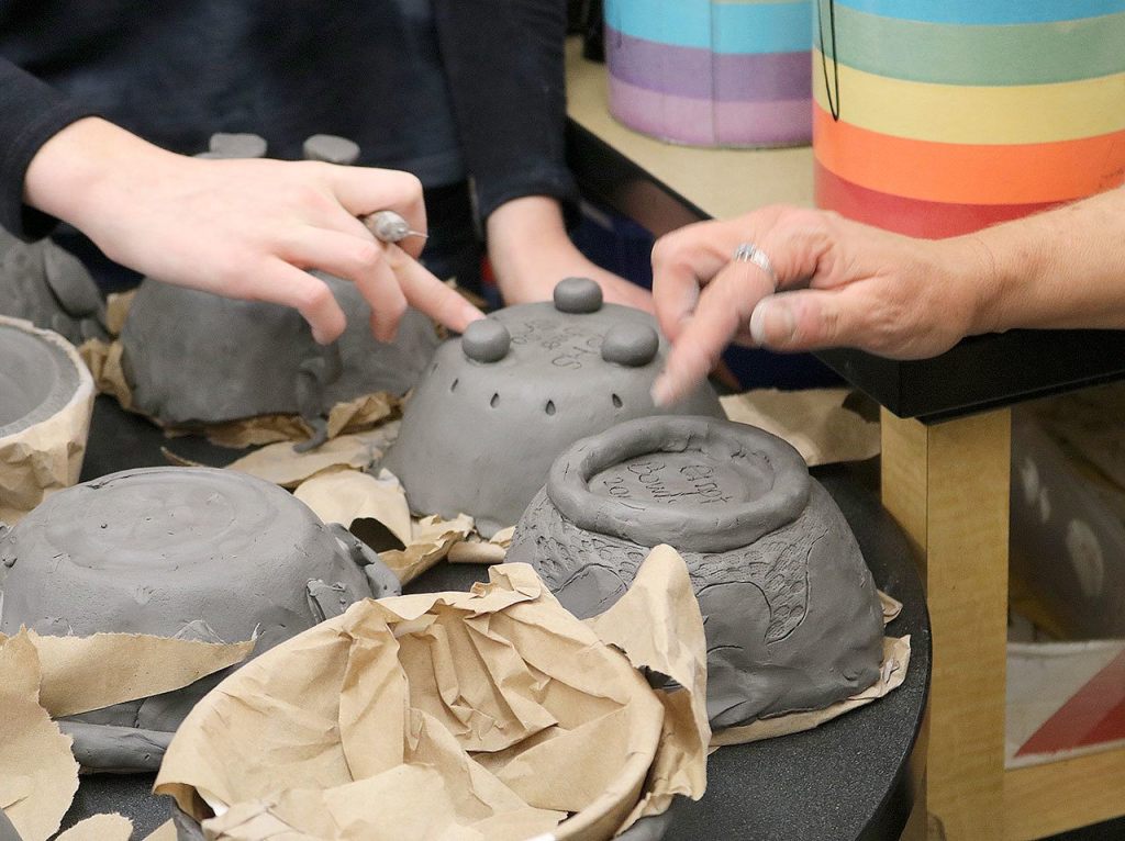 Students work on the finishing touches of their creations for the 2017 Empty Bowls event. Evan Pappas/Staff Photo