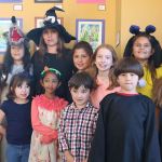 Snoqualmie Smart with Art students, dressed in their Halloween costumes, pose with their teacher at the Snoqualmie Valley Chamber of Commerce building. Front-row from left: Maria Castle, Vendanshi Rahul, Albert Brown and John David Castle. Back-row from left: Bella Vernon, Franchesca Tamburini, Smart with Art Teacher Kori Mankowski, Cynthia Castle, Eva Davison, Hailey Mays and Evelyn Brown. (Evan Pappas/Staff Photo)
