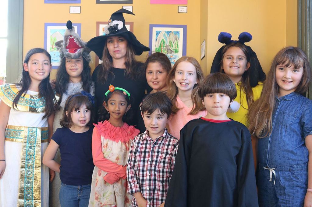 Snoqualmie Smart with Art students, dressed in their Halloween costumes, pose with their teacher at the Snoqualmie Valley Chamber of Commerce building. Front-row from left: Maria Castle, Vendanshi Rahul, Albert Brown and John David Castle. Back-row from left: Bella Vernon, Franchesca Tamburini, Smart with Art Teacher Kori Mankowski, Cynthia Castle, Eva Davison, Hailey Mays and Evelyn Brown. (Evan Pappas/Staff Photo)
