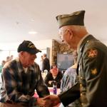 Bob Hamerly and Harley Brumbaugh shake hands at the Mount Si Senior Center after not having seen each other in some time. (Evan Pappas/Staff Photo)