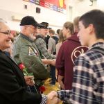 Veterans Casondra Brewster, Rich Collingwood and Mike Bryant shake the hands of Mount Si High School Students who they formed a line to thank the veterans for their service. (Evan Pappas/Staff Photo)