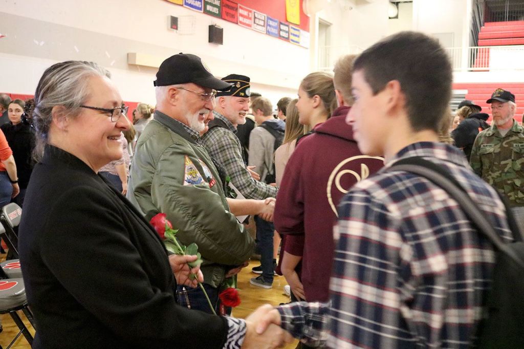 Veterans Casondra Brewster, Rich Collingwood and Mike Bryant shake the hands of Mount Si High School Students who they formed a line to thank the veterans for their service. (Evan Pappas/Staff Photo)