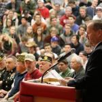 Mount Si High School&rsquo;s Athletic Director Ray Wilson introduces the invited veterans to the students and plays an introductory video for the school assembly. (Evan Pappas/Staff Photo)