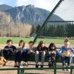 Curled up in the sunshine with their books are, from left, Elizabeth Conlon, Mallory Osborne, Taylor McCarthy, Kelsey Lingo, Taneesha Sharmin and Paige Horner, all students in Heidi Smith&rsquo;s class who spent part of Thursday reading outside.