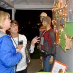 Michele McNany and Karen Birzell talk at the food bank&rsquo;s open house, next to mannequins representing food bank clients.                                Carol Ladwig/Staff Photo