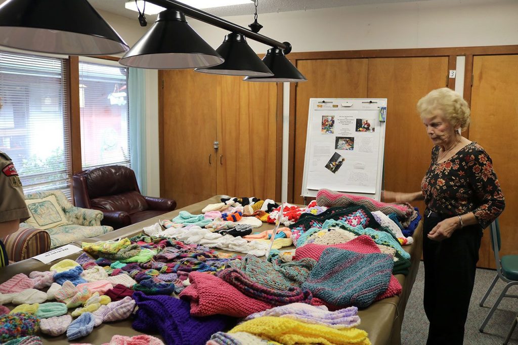 Mount Si Senior Center&rsquo;s Yarn Therapy Group and the American Legion Auxiliary made clothing for the children and families of veterans. (Evan Pappas/Staff Photo)