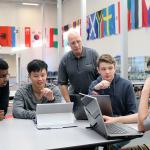 Evan Pappas/Staff Photo                                Mount Si seniors Vishnu Rathnam, Donavan See, Preston Henning and Andy Kirby discuss an upcoming competition while club advisor Stephen Kangas answers their questions.