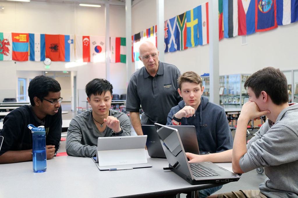 Evan Pappas/Staff Photo                                Mount Si seniors Vishnu Rathnam, Donavan See, Preston Henning and Andy Kirby discuss an upcoming competition while club advisor Stephen Kangas answers their questions.