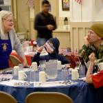 Sandy DuVall, a Rotary volunteer, talks with Calvin, Nate, Janya and Glen Veranth at the breakfast.