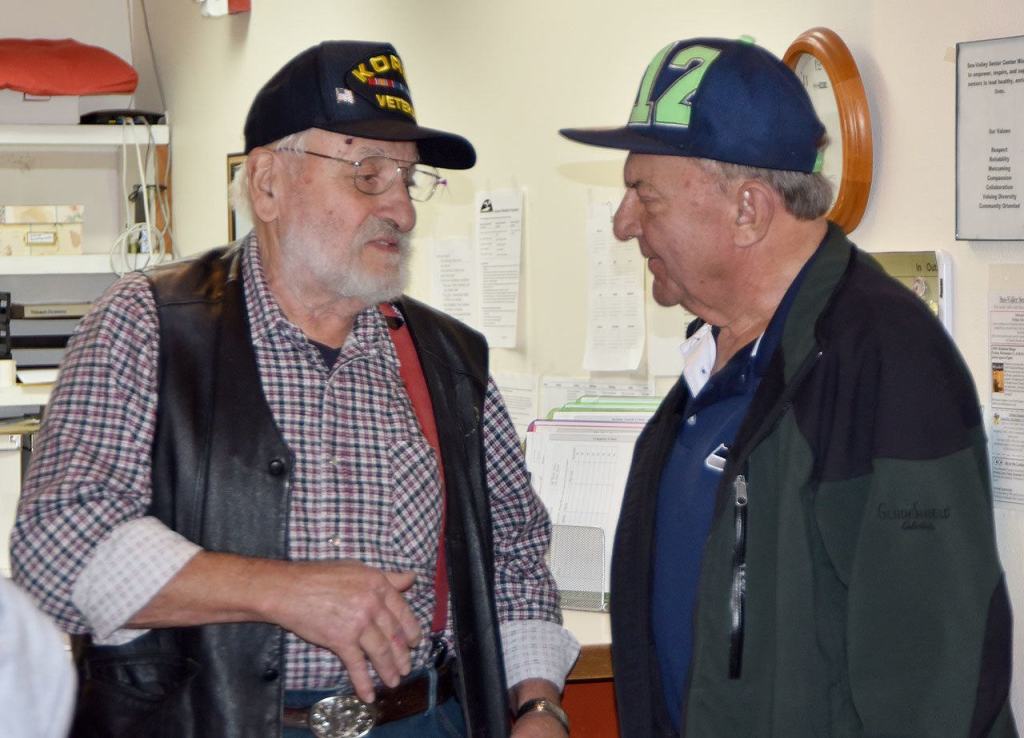 George Board and Jim Roetcisoender swap stories outside the Veterans Day breakfast in Carnation. (Carol Ladwig/Staff Photo)