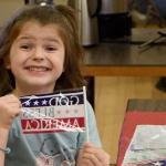 Kyle Watson enthusiastically waves her flag at the Sno-Valley Senior Center breakfast Friday. (Carol Ladwig/Staff Photo)