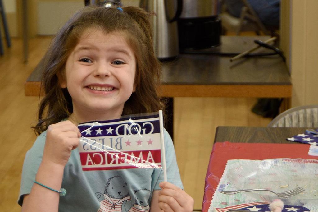 Kyle Watson enthusiastically waves her flag at the Sno-Valley Senior Center breakfast Friday. (Carol Ladwig/Staff Photo)