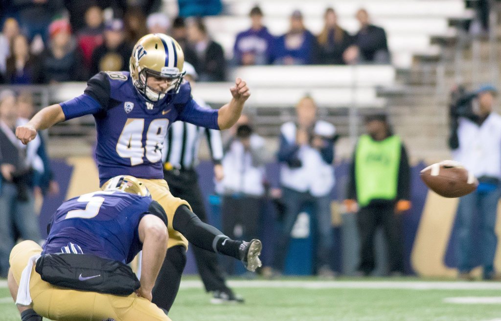 Cameron Van Winkle kicks an extra point, while Jeff Lindquist holds, against Arizona State Saturday. After the night was over, Van Winkle set a Husky record for the most PAT&rsquo;s in a season.                                James Gibowski Photo