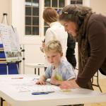Susan Kingsbury-Comeau shows her son Damien the design plans for the new bike park. (Evan Pappas/Staff Photo)