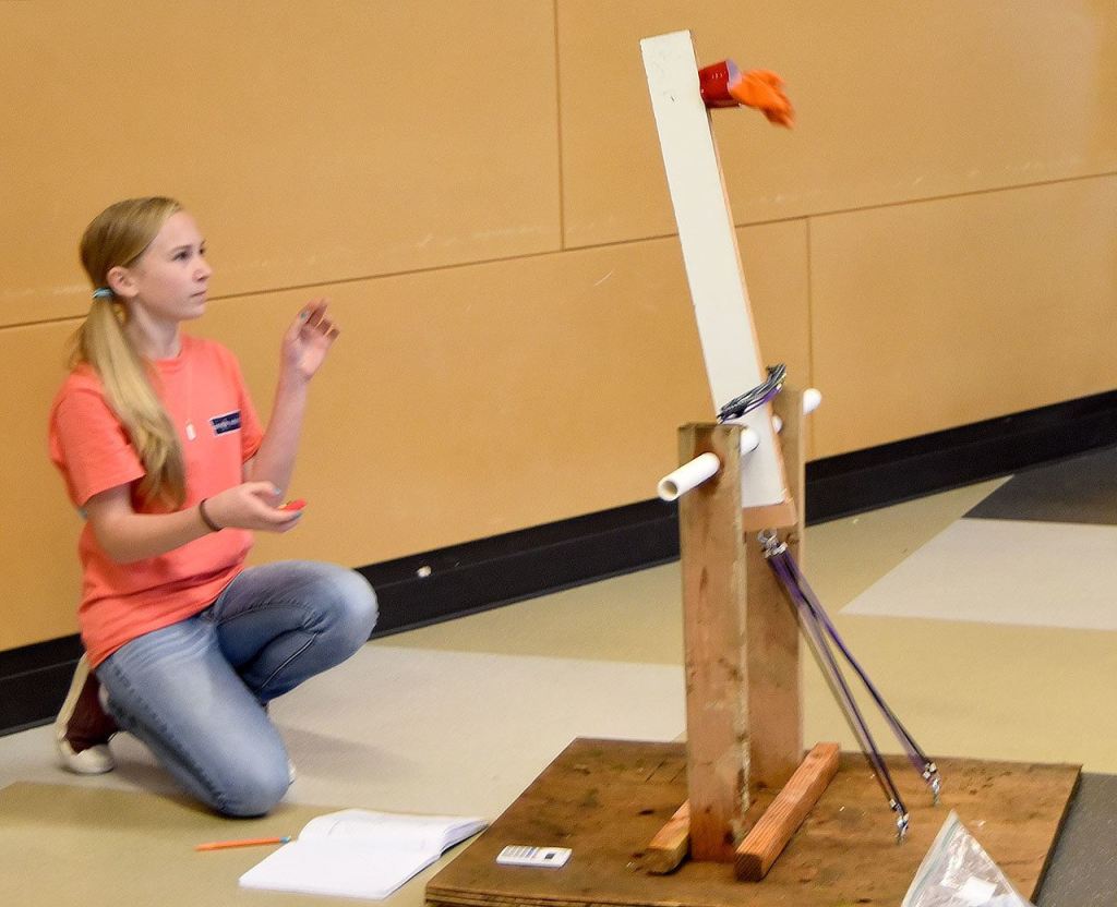 Sixth grader Sydney Dunn tests her catapult in the Twin Falls Middle School commons last Wednesday.                                Carol Ladwig/Staff Photo